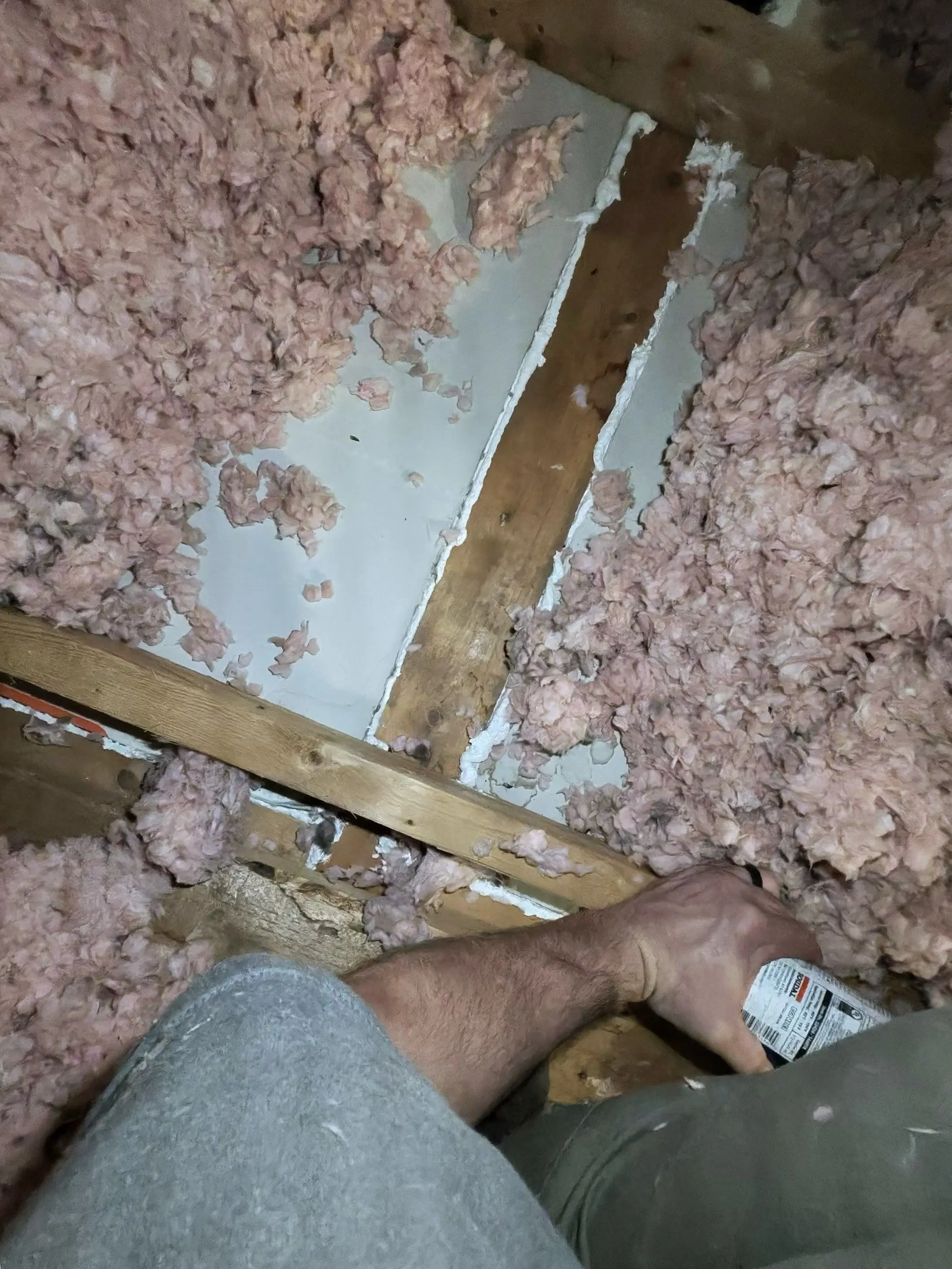 Fiberglass insulation laid between attic joists