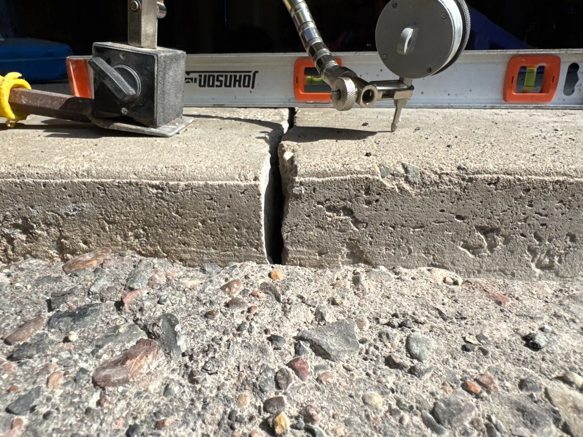 Close-up of the gap where a concrete slab settled away from the adjoining section