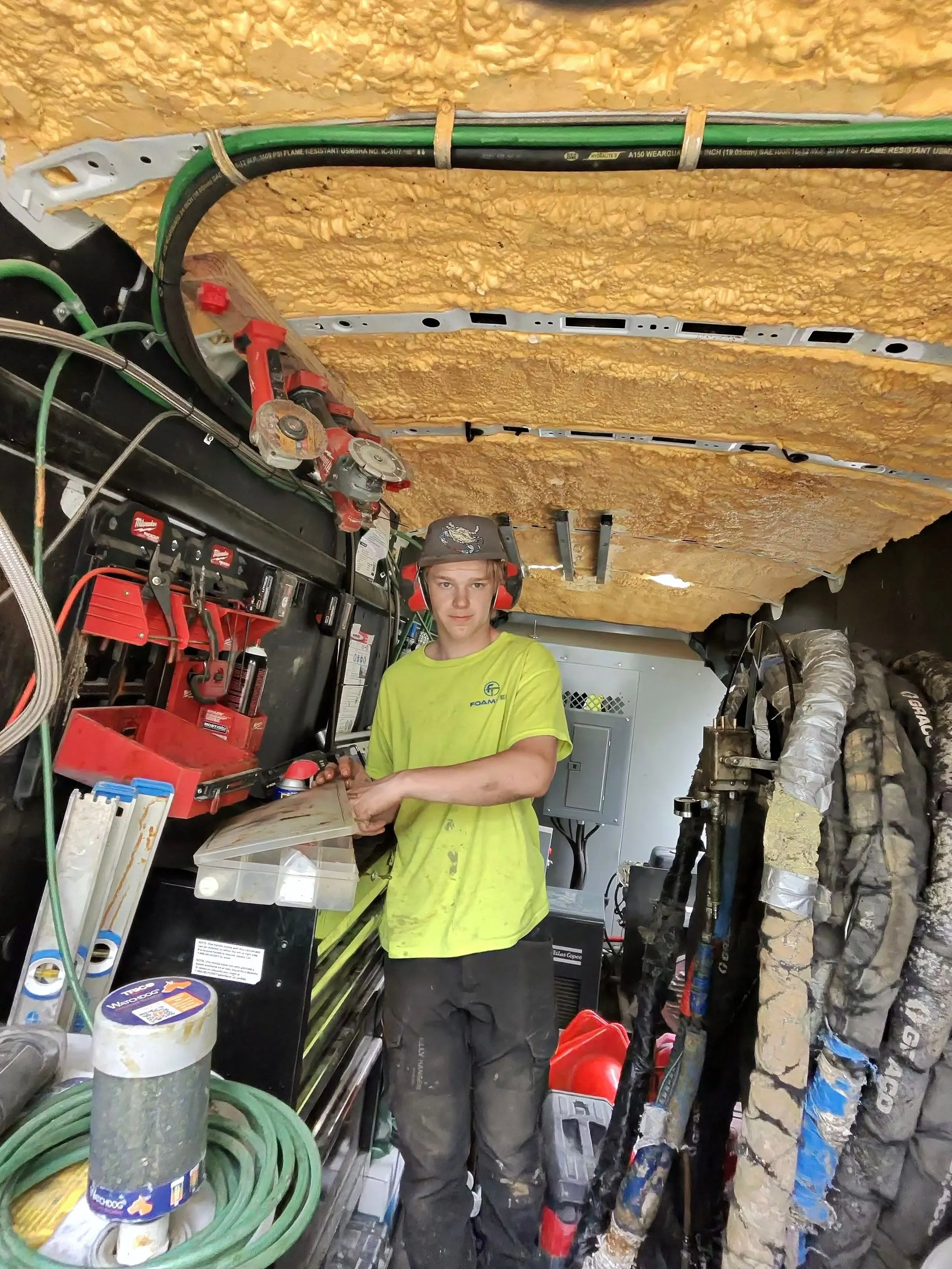 Foam-Tek technician with the spray rig inside the company service van